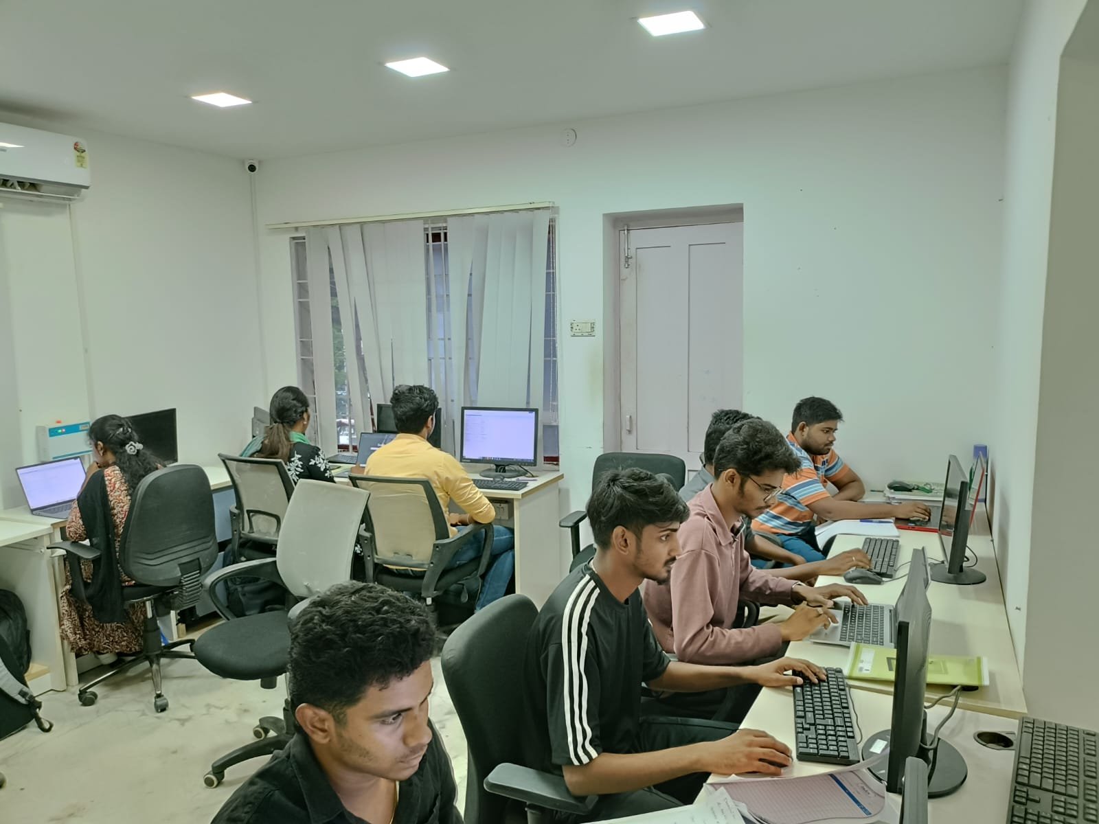 Students working hands-on at computer workstations at Techmaax Anna Nagar